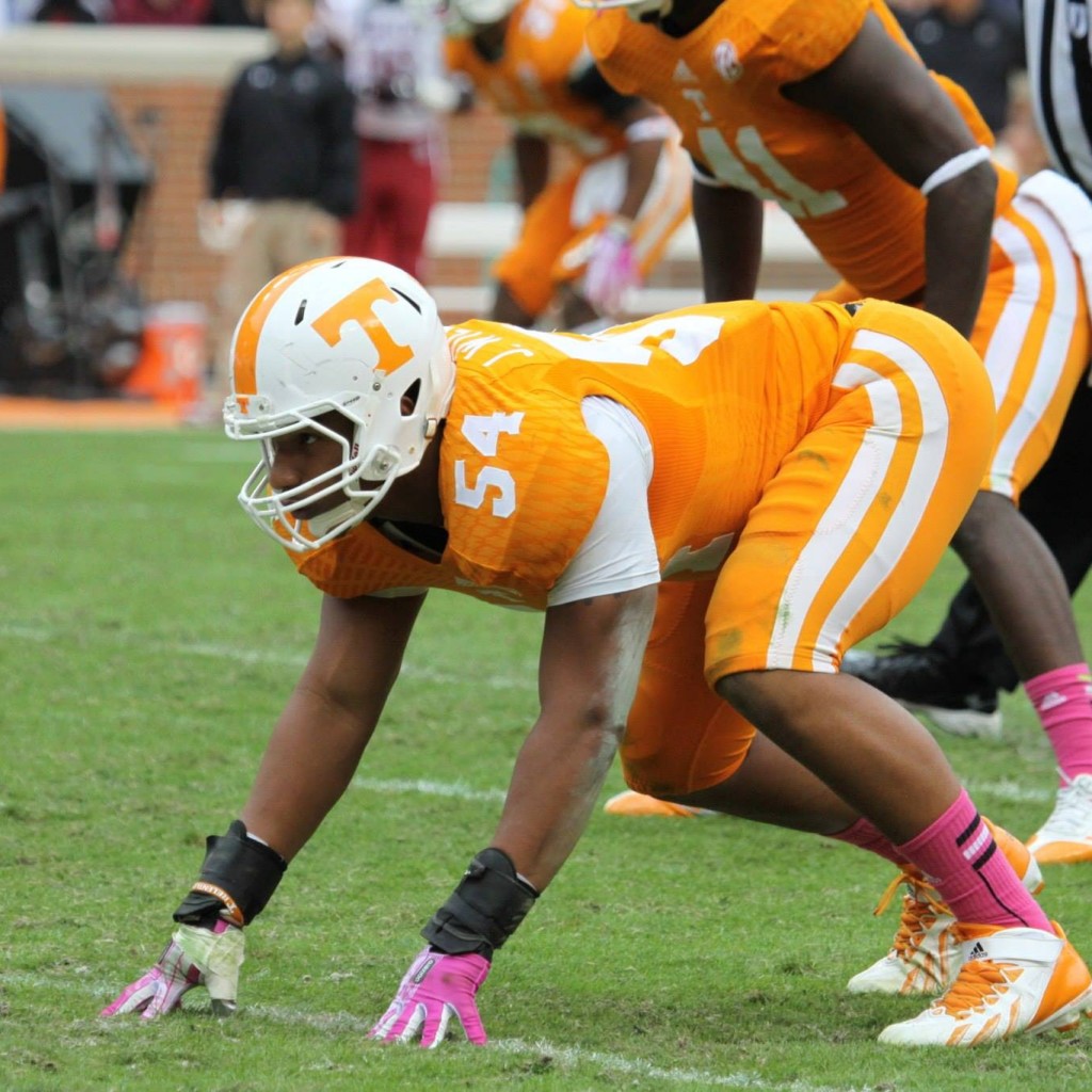 A football player is getting ready to run.